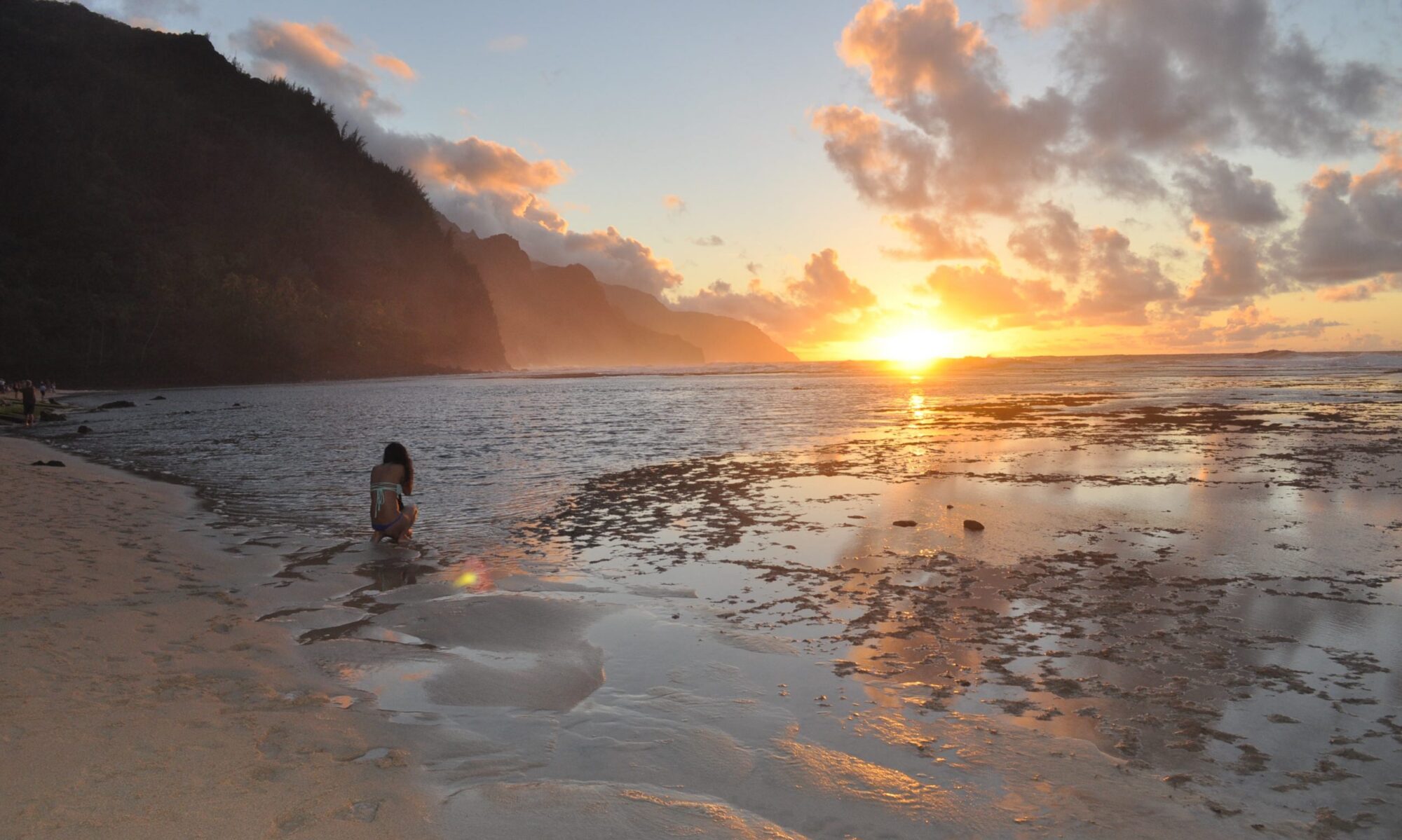 Hawaiian woman infront of sunset on Kauai